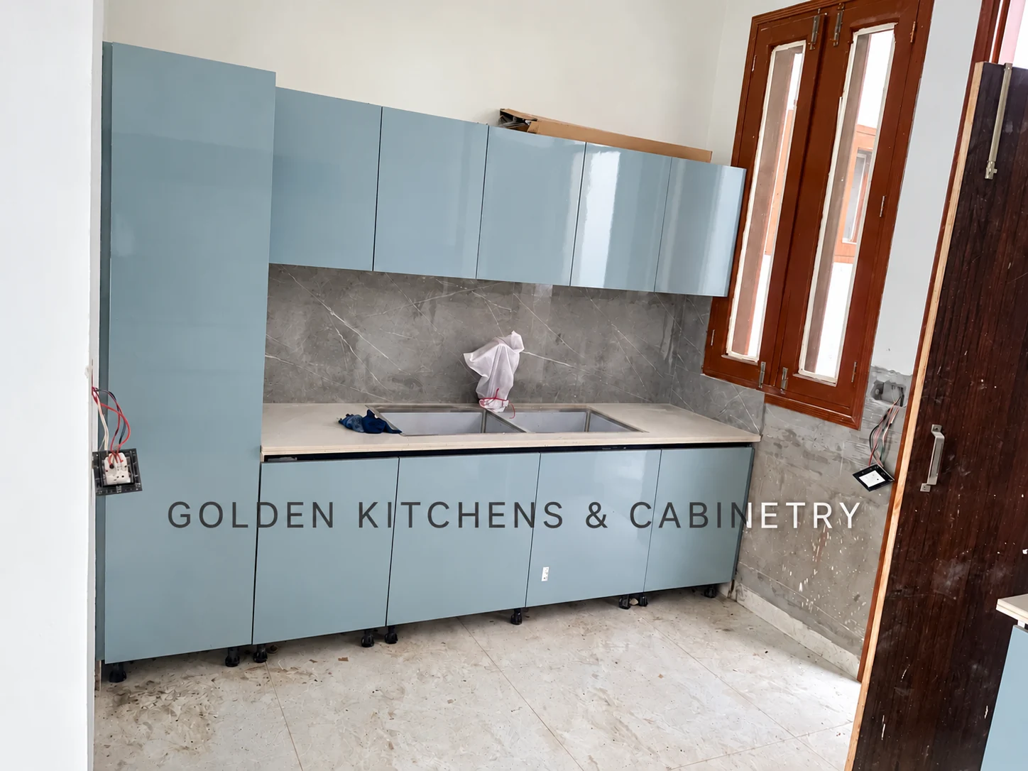 Pale blue kitchen sink wall during installation
