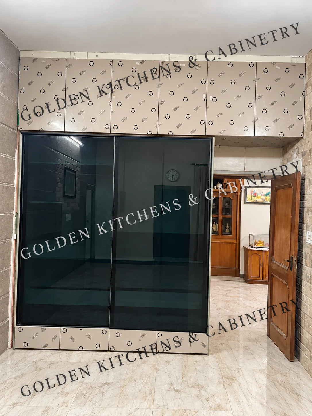 Tinted-glass sliding wardrobe during installation